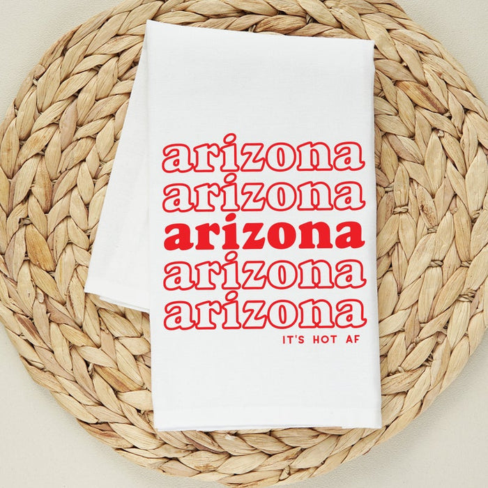 White towel printed with red Arizona repeated in a column and It's Hot AF at the bottom