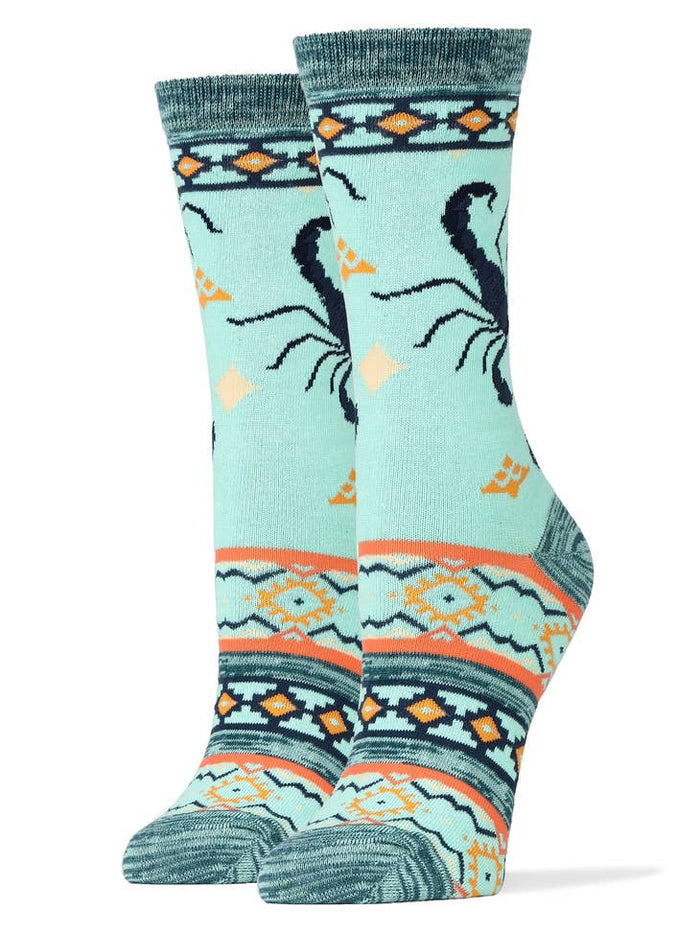 Scorpion Bite women's socks in pale blue with a scorpion motif and southwestern border designs