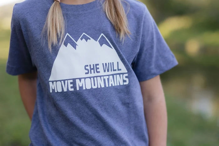 Blue heathered toddler tee with a white mountain graphic and the She Will Move Mountains slogan