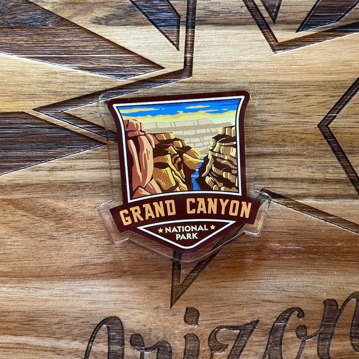 Grand Canyon badge acrylic magnet on a wooden surface