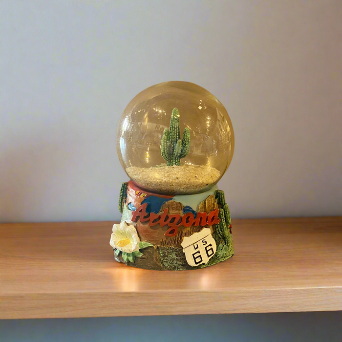Arizona sand globe with a cactus inside a clear glass sphere on a decorative base labeled Route 66