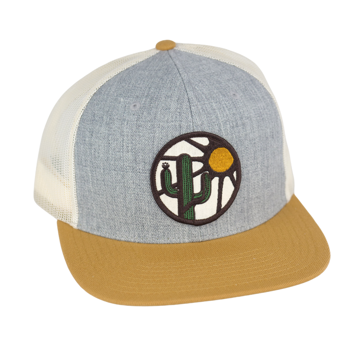 Light blue heather front panel trucker with white mesh and tan brim, desert cactus and sun patch on the front.