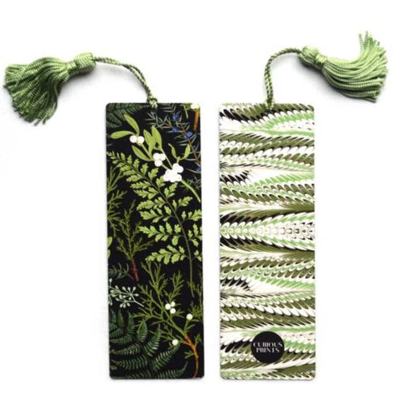 Pair of fern themed bookmarks with green tassels; one black with white blossoms, the other green marbled fern stripe