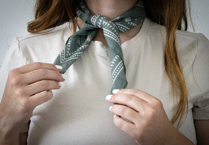 Green cactus print cotton bandana tied around a neck