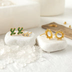 Gold cactus shaped stud earrings with green stones from the Cactus Stud Gift Set, displayed on white stones