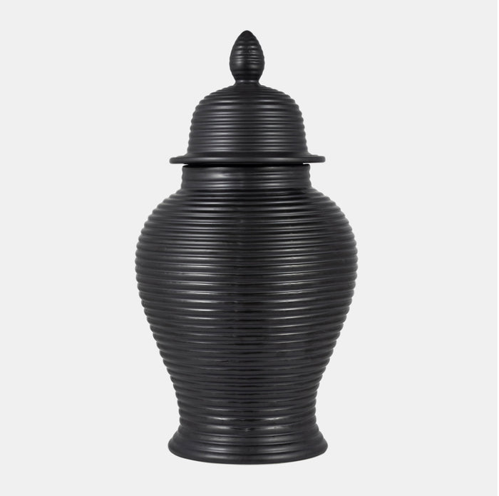 Black ribbed urn with lid on a white background.