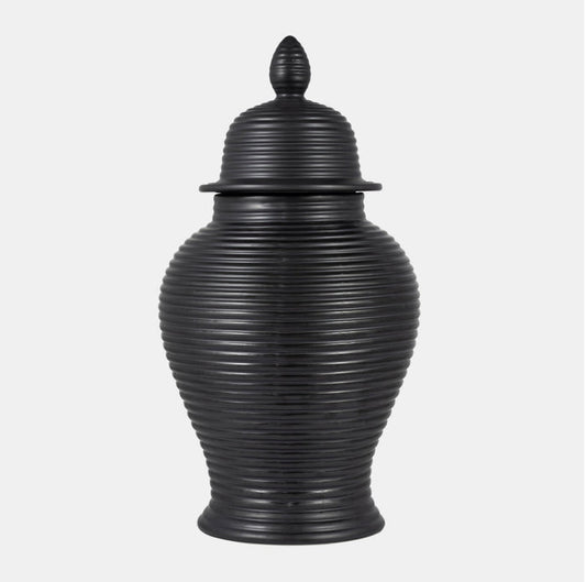 Black ribbed urn with lid on a white background.
