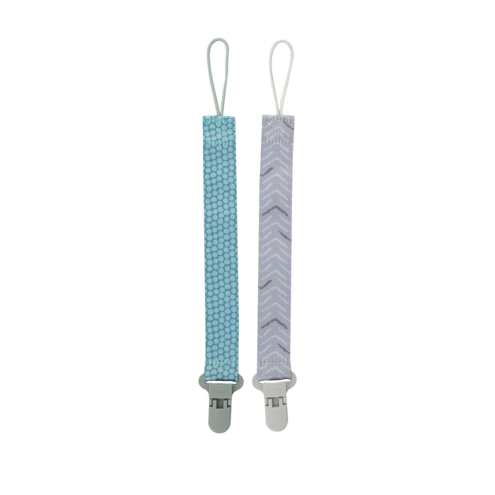 The Cloth Pacifier Clip (2 Pack) includes one blue patterned and one light gray chevron strap, each with a plastic clip and a white elastic loop for attaching your pacifier.