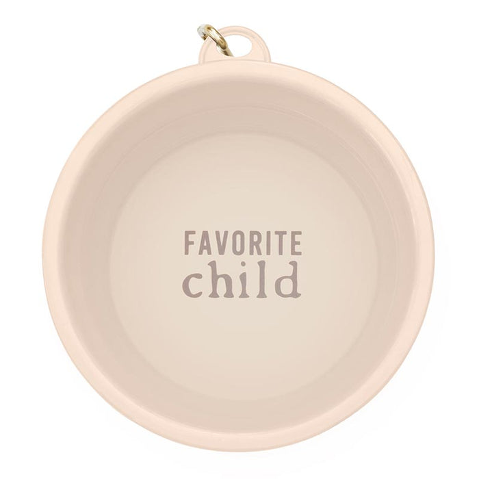 Collapsible pale pink bowl with a gold carabiner and Favorite Child printed inside.
