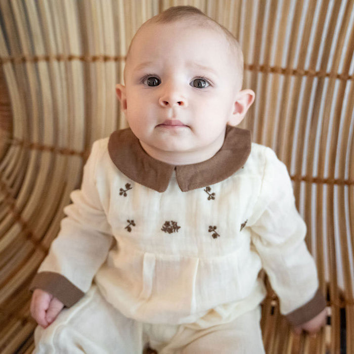 Baby wearing Organic Embroidered Crinkle Muslin Baby Jumpsuit