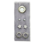 Flower Stud Gift Set on grey velvet shows a large round gold stud at top, two small crystal studs, two star crystal studs, and sunburst earrings