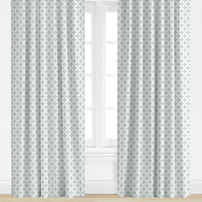 blue Patterned curtains on a window with a light background