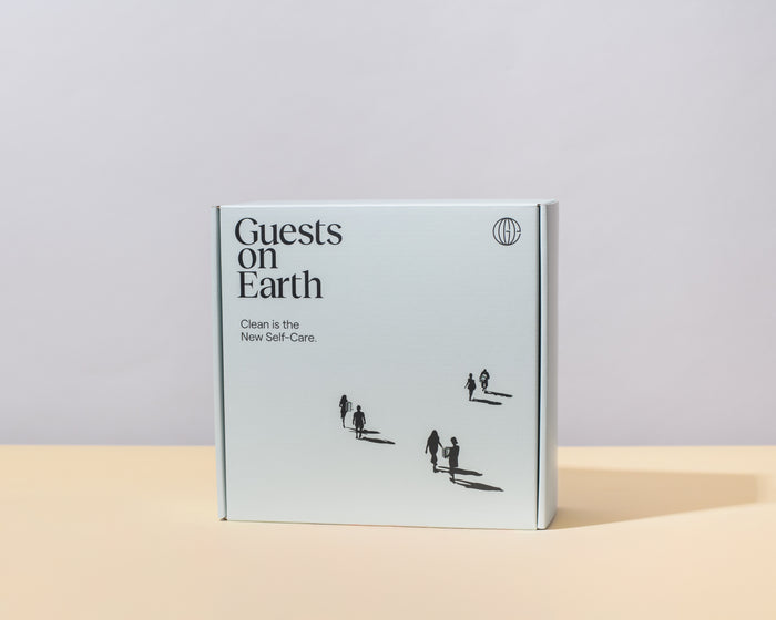 Guests on Earth Gift Box in minimalist white packaging on a neutral backdrop, ready to give