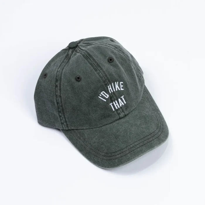 Angled view of a distressed dark green dad hat with white ID HIKE THAT embroidery on the front.