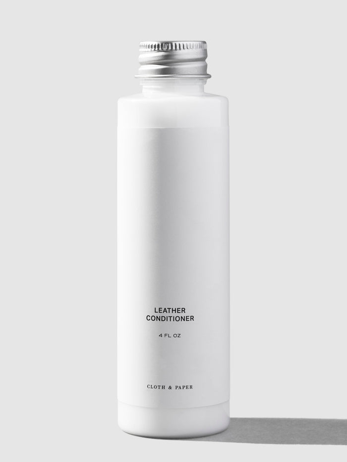 Leather conditioner, Cloth and Paper. Conditioner displayed on a neutral background.