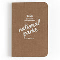 Brown fabric covered One Hundred National Parks Journal with white script title.