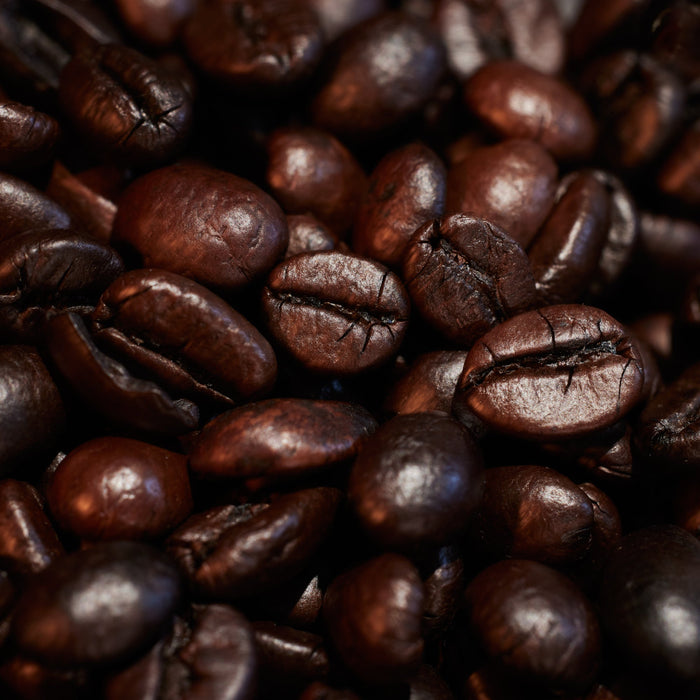 Close-up of roasted coffee beans with a dark background