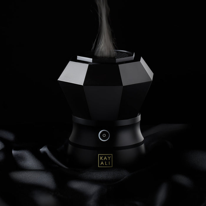Black geometric bahkoor maker with steam rising, brand 'KAYALI' visible