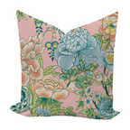 Floral pillow with blue and green flowers on a pink background