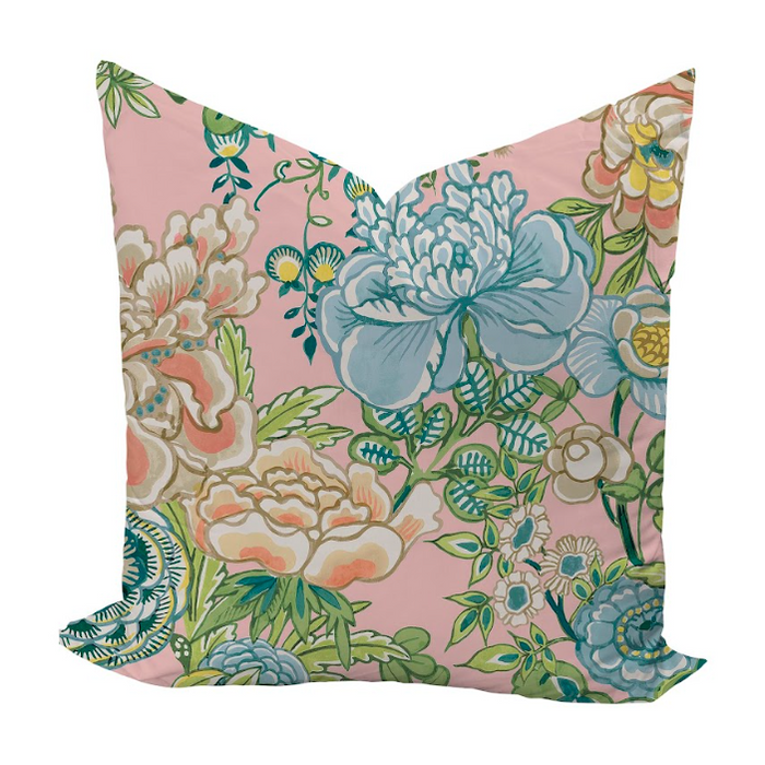 Floral pillow with blue and green flowers on a pink background