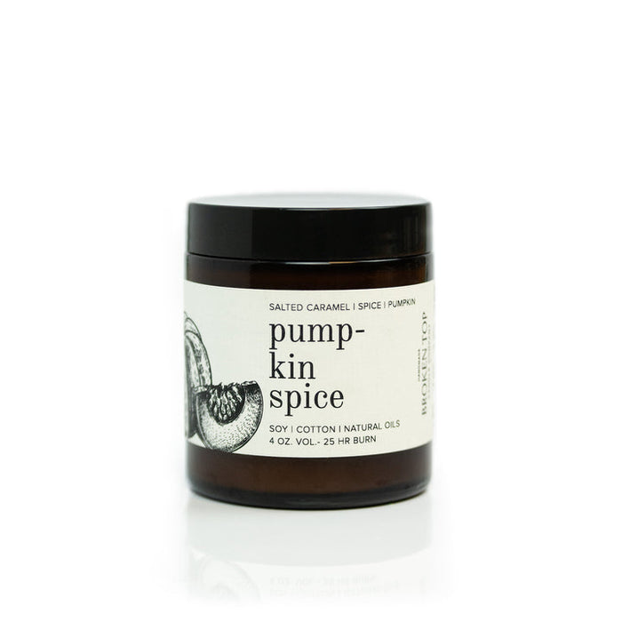 4 oz pumpkin spice candle in a dark brown jar with black lid and cream label