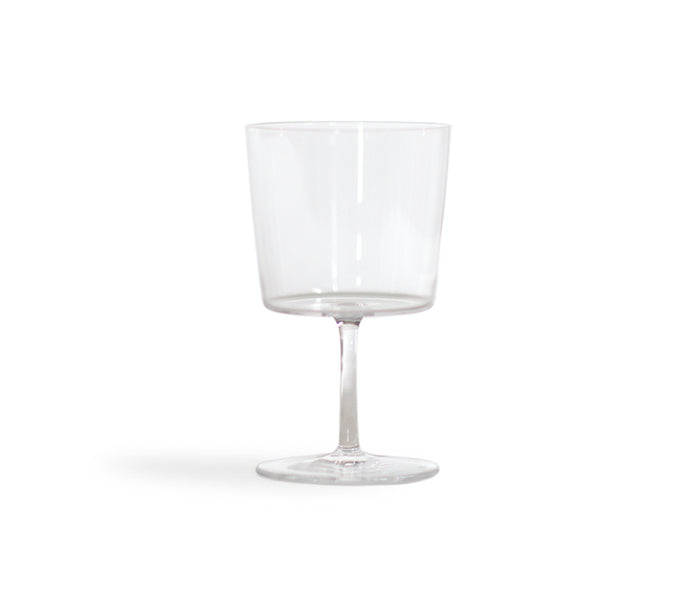 Silhouetted time and style raisin glass against white background.