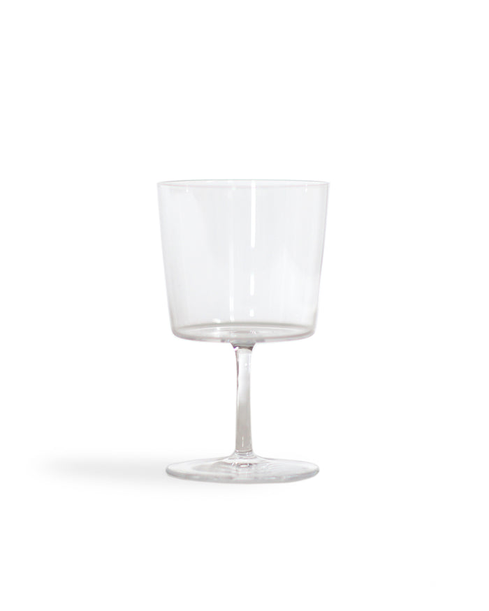 Silhouetted time and style raisin glass against white background.