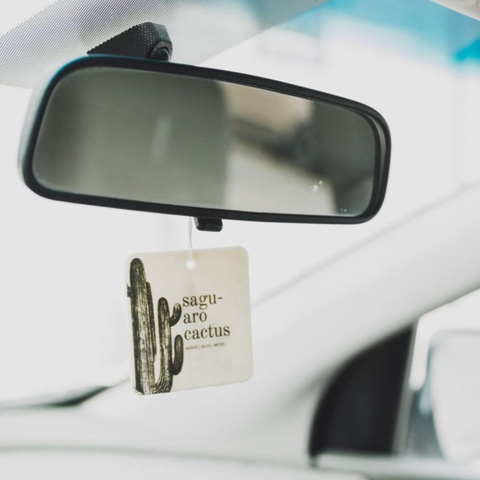 Saguaro cactus air freshener hanging from a car rearview mirror.