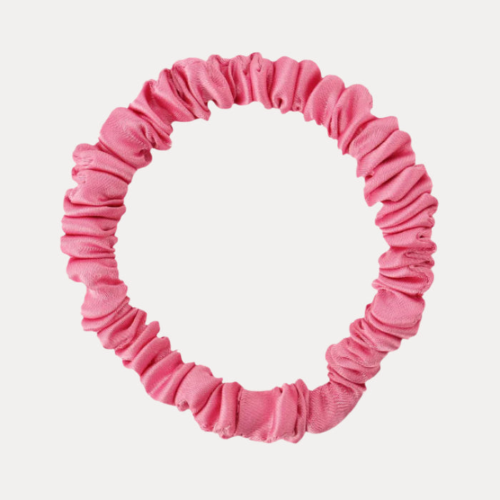 a pink scrunchie on a white background