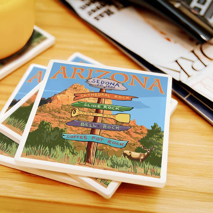Stack of coasters with the Sedona signpost artwork on top.