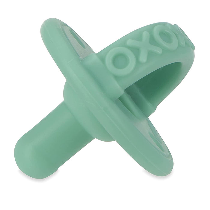 The Sili Soother Pacifier (2 Pack) features green silicone pacifiers with ring handles and the OXO brand embossed on the rim, ideal for soothing your baby.
