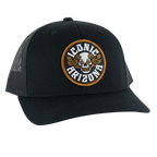 Black curved brim hat with round embroidered patch showing a skull surrounded by orange flowers and Iconic Arizona text.