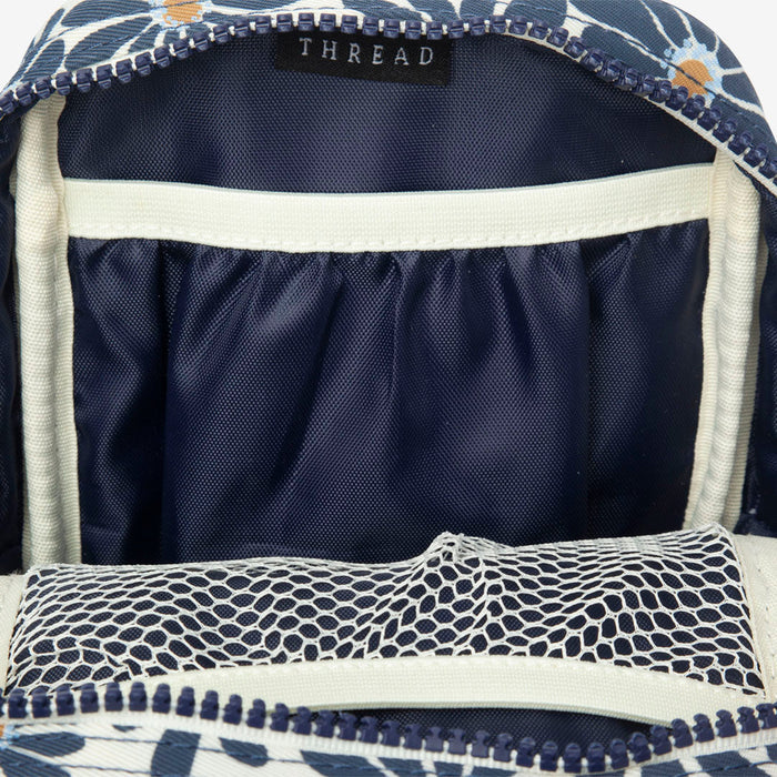Interior of Thread crossbody bag with navy lining and white trim along the opening.