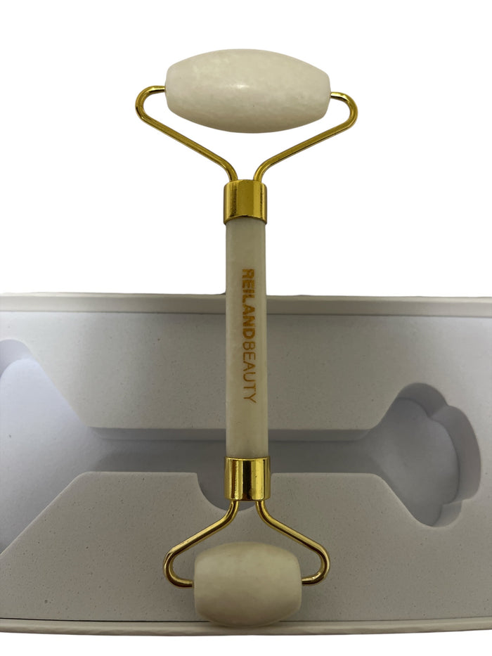 Facial massage using a white jade roller as part of a skincare routine