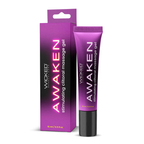 A product shot of the new packaging for Wicked "Awaken" stimulating clitoral massage gel against a plain white background. It features a rectangular box on the left and a squeeze tube on the right. Both share a vibrant purple and black color scheme with the word "AWAKEN" printed vertically in a glowing pink font, followed by the text "stimulating clitoral massage gel" and the volume "15 ml / 0.5 fl oz" near the bottom.