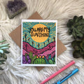 You are my sunshine greeting card with a bright yellow sun, turquoise sky and purple desert hills with cacti.